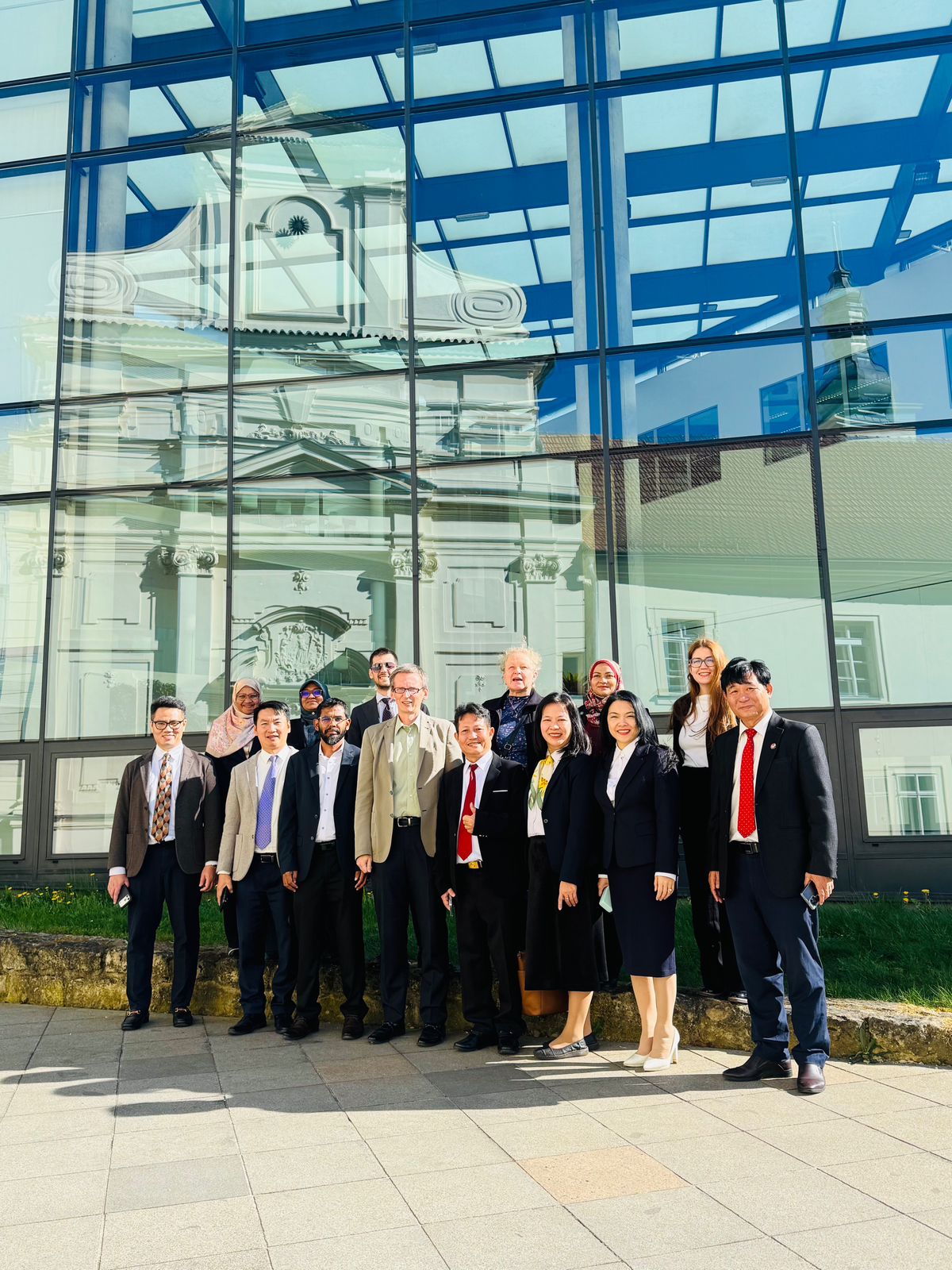 SUSTAIN partners gathered outside a glass-fronted building
